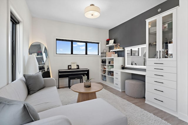 living area featuring light wood-type flooring and baseboards