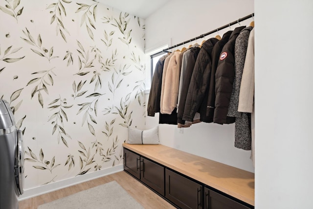 mudroom with baseboards, wallpapered walls, and light wood finished floors
