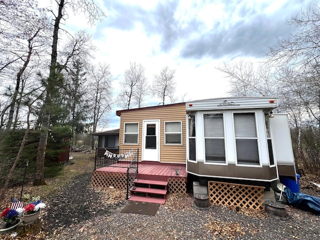 back of house with a deck