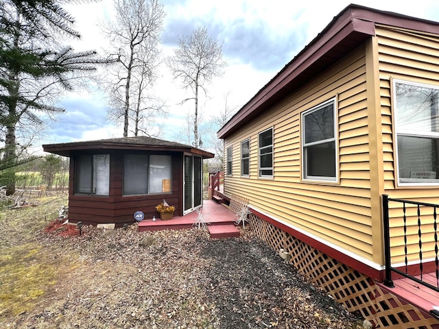 view of side of home with a wooden deck