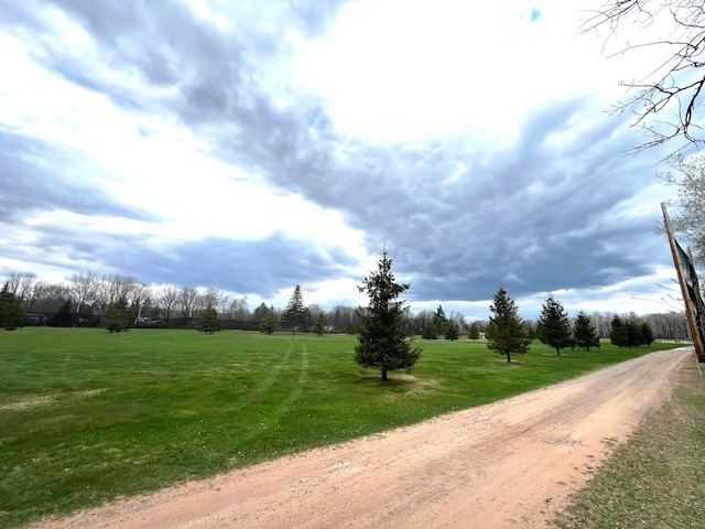 view of dirt / gravel road with a view of rural / pastoral area