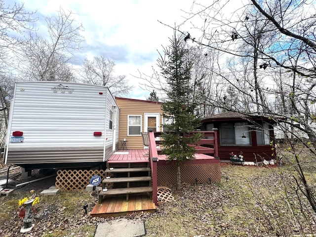 back of property with a wooden deck