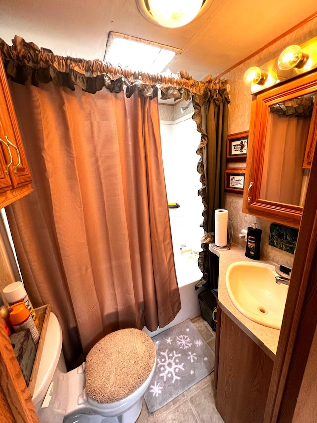 bathroom with vanity, toilet, and tile patterned floors