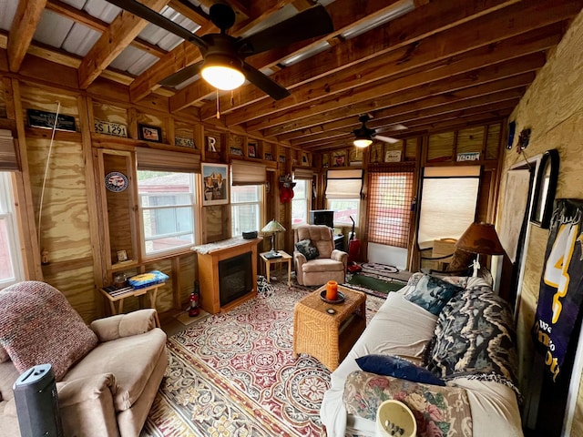 sunroom / solarium featuring beamed ceiling