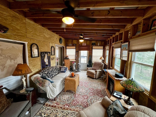 living room featuring ceiling fan and healthy amount of natural light