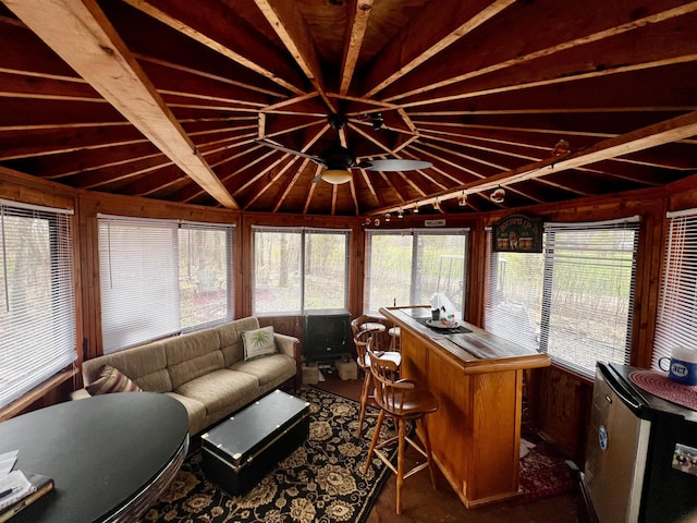 sunroom / solarium featuring wooden walls