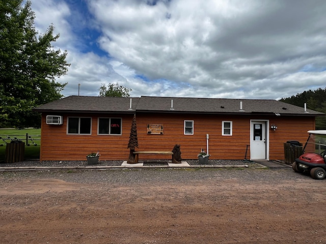 view of front of property with an AC wall unit