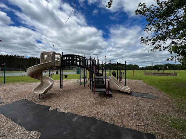 communal playground featuring a lawn