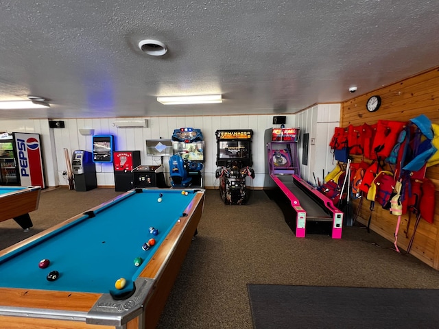 recreation room with pool table, carpet, a textured ceiling, wood walls, and a wall mounted AC