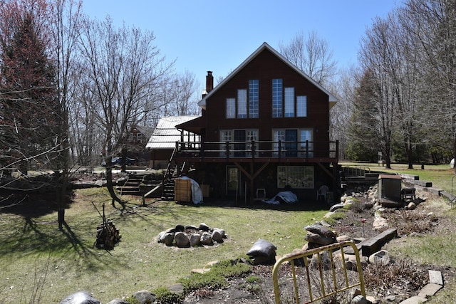30472 Lightning Pass Unit 1, Turtle Creek Twp, MN 56443 - rear view of property featuring a fire pit, a wooden deck, a chimney, a lawn, and stairway