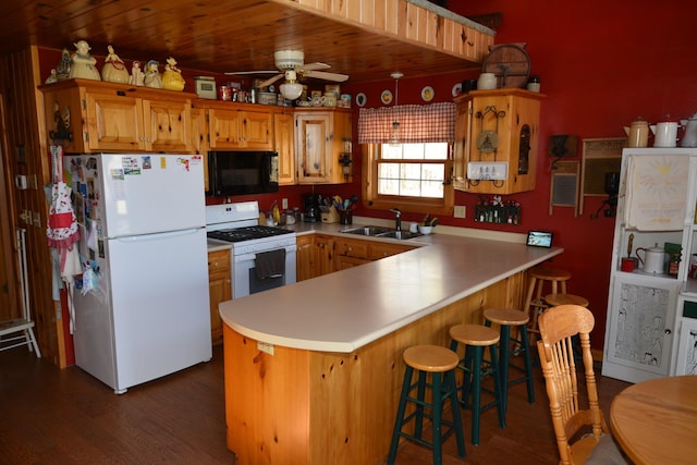 30472 Lightning Pass Unit 1, Turtle Creek Twp, MN 56443 - kitchen with white appliances, a peninsula, a sink, and dark wood-type flooring