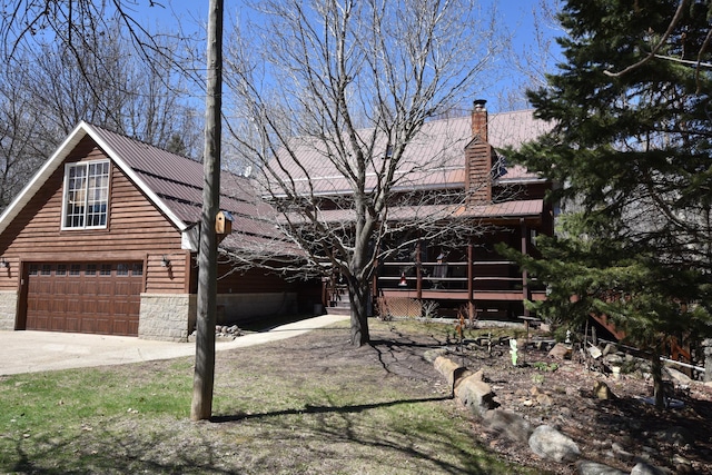 30472 Lightning Pass Unit 1, Turtle Creek Twp, MN 56443 - view of front facade with driveway, metal roof, and a chimney