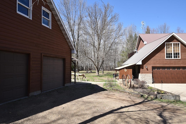 30472 Lightning Pass Unit 1, Turtle Creek Twp, MN 56443 - view of property exterior with an attached garage and stone siding