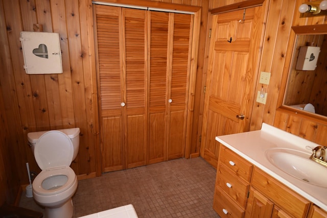 30472 Lightning Pass Unit 1, Turtle Creek Twp, MN 56443 - bathroom featuring toilet, wood walls, and vanity