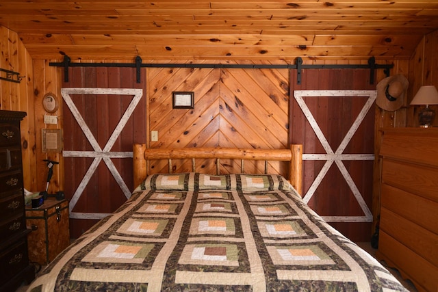 30472 Lightning Pass Unit 1, Turtle Creek Twp, MN 56443 - unfurnished bedroom with a barn door, wood walls, and wooden ceiling