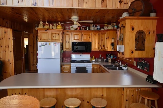30472 Lightning Pass Unit 1, Turtle Creek Twp, MN 56443 - kitchen featuring a ceiling fan, a peninsula, white appliances, light countertops, and a sink