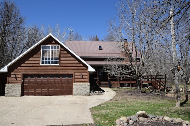 30472 Lightning Pass Unit 1, Turtle Creek Twp, MN 56443 - view of front of home with a garage, driveway, metal roof, and stone siding