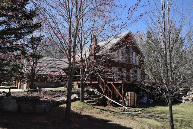 30472 Lightning Pass Unit 1, Turtle Creek Twp, MN 56443 - back of property featuring a wooden deck, stairs, and a chimney