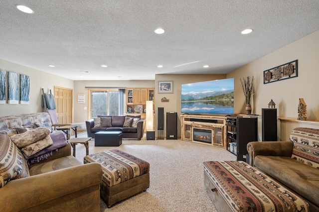 living room featuring recessed lighting, carpet flooring, a textured ceiling, and a glass covered fireplace