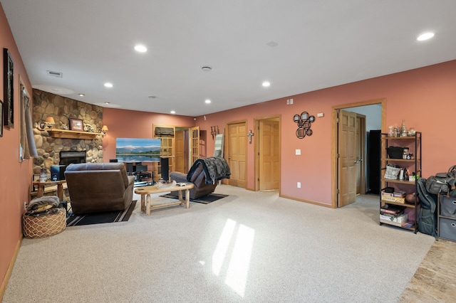 living room featuring recessed lighting, visible vents, light carpet, and a fireplace