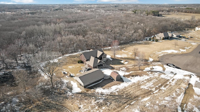 snowy aerial view with a forest view