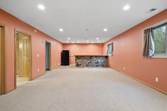 unfurnished living room featuring light colored carpet, baseboards, visible vents, and recessed lighting