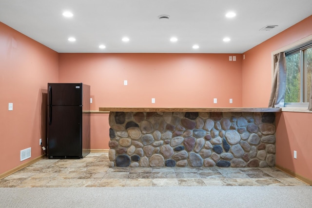 kitchen featuring baseboards, freestanding refrigerator, recessed lighting, and visible vents