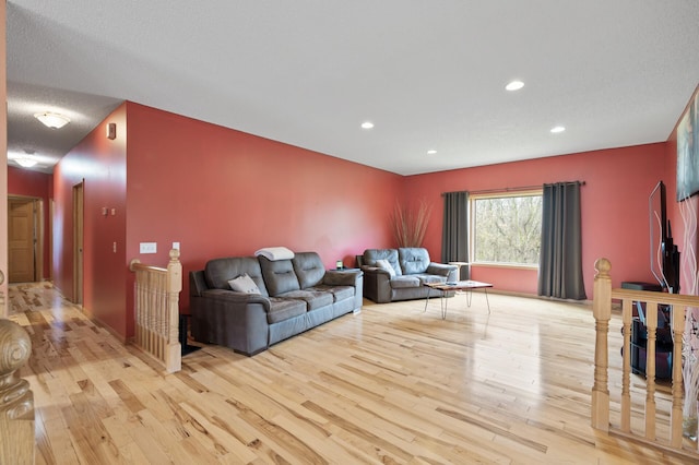 living room featuring wood-type flooring and recessed lighting