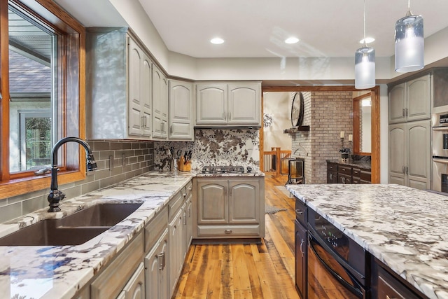1055 Nelson Dr, Shoreview, MN 55126 - kitchen featuring a sink, light wood-type flooring, light stone countertops, backsplash, and stainless steel appliances