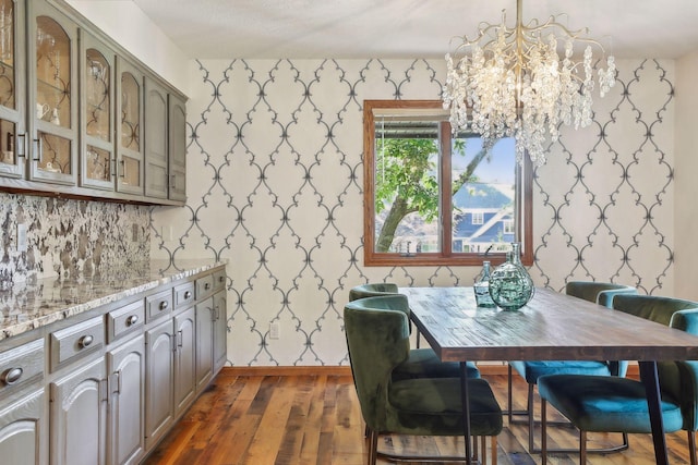 1055 Nelson Dr, Shoreview, MN 55126 - dining room featuring a chandelier, dark wood-style flooring, and wallpapered walls