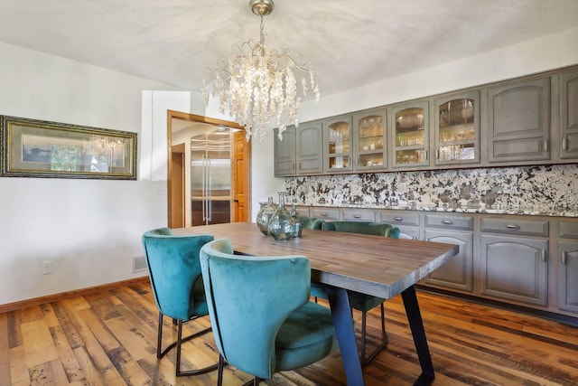 1055 Nelson Dr, Shoreview, MN 55126 - dining area featuring a chandelier, dark wood-style flooring, and baseboards