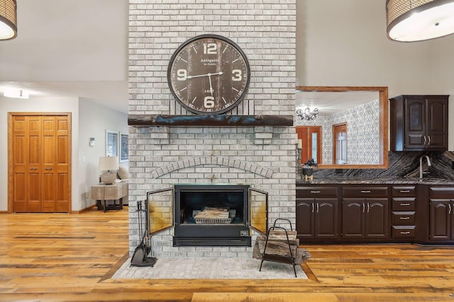 1055 Nelson Dr, Shoreview, MN 55126 - living area featuring light wood-style flooring and a brick fireplace
