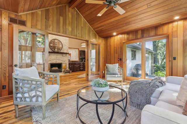 1055 Nelson Dr, Shoreview, MN 55126 - living area featuring wooden ceiling, vaulted ceiling, wood finished floors, a ceiling fan, and a brick fireplace