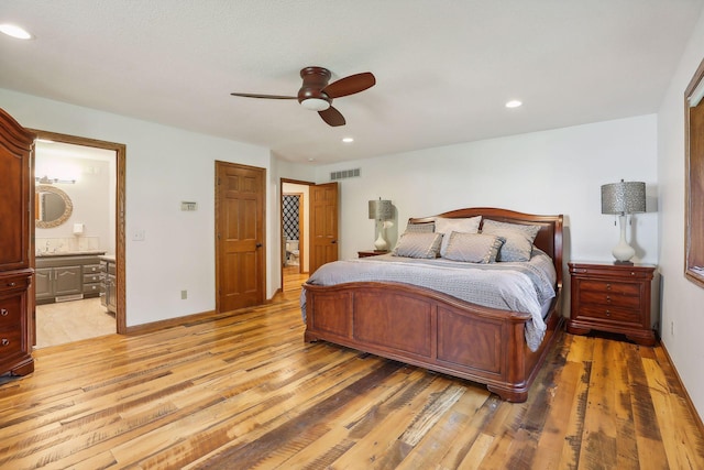 1055 Nelson Dr, Shoreview, MN 55126 - bedroom with light wood-style flooring, ensuite bathroom, recessed lighting, ceiling fan, and baseboards