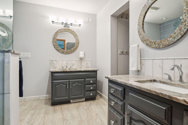 1055 Nelson Dr, Shoreview, MN 55126 - bathroom featuring baseboards, two vanities, and marble look tile flooring