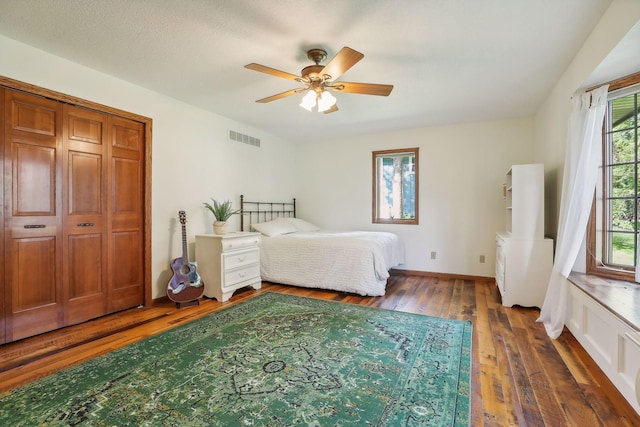 1055 Nelson Dr, Shoreview, MN 55126 - bedroom featuring multiple windows, wood-type flooring, a ceiling fan, and baseboards
