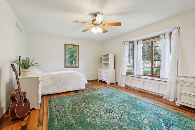 1055 Nelson Dr, Shoreview, MN 55126 - bedroom featuring multiple windows, wood finished floors, and a ceiling fan