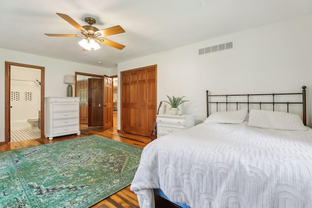 1055 Nelson Dr, Shoreview, MN 55126 - bedroom featuring wood finished floors, connected bathroom, and ceiling fan