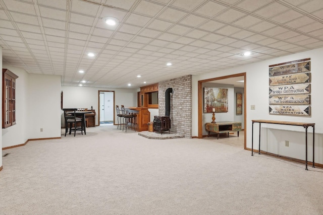 1055 Nelson Dr, Shoreview, MN 55126 - living room featuring a wood stove, carpet flooring, baseboards, and recessed lighting