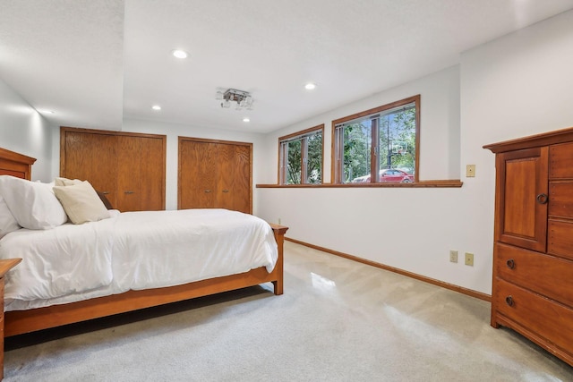 1055 Nelson Dr, Shoreview, MN 55126 - bedroom featuring baseboards, recessed lighting, two closets, and light carpet