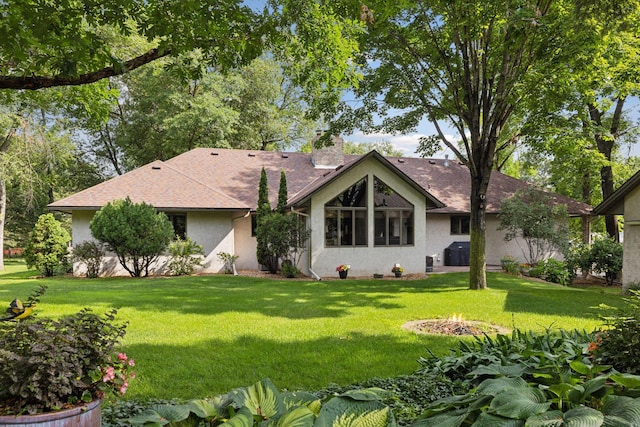 1055 Nelson Dr, Shoreview, MN 55126 - ranch-style home featuring a front yard, stucco siding, a fire pit, a shingled roof, and a chimney