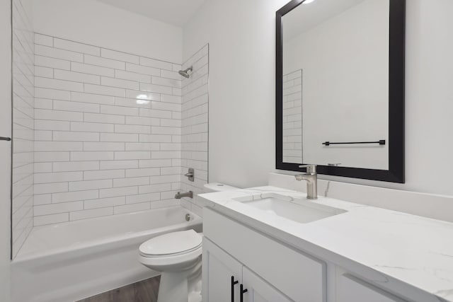 bathroom featuring vanity,  shower combination, wood finished floors, and toilet