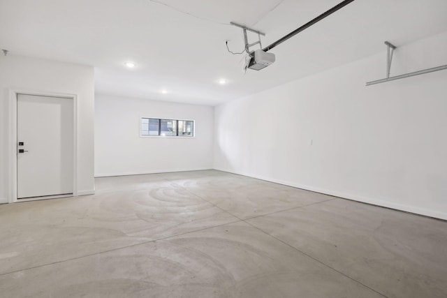 garage with baseboards, a garage door opener, and recessed lighting