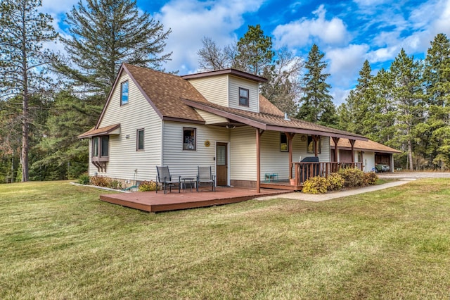 9700 Aspen Ave NW, Bemidji, MN 56601 - view of front of home featuring a front lawn, roof with shingles, and a deck