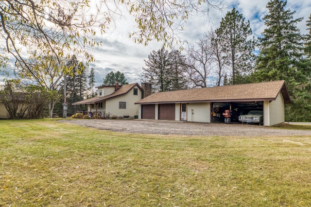 9700 Aspen Ave NW, Bemidji, MN 56601 - exterior space with a lawn, a chimney, an outbuilding, and a garage
