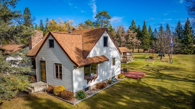 9700 Aspen Ave NW, Bemidji, MN 56601 - back of property with a yard, a deck, a chimney, and roof with shingles