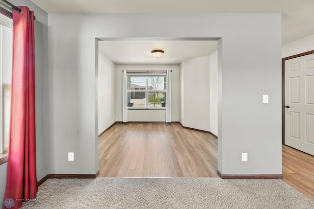 unfurnished room with wood finished floors and baseboards