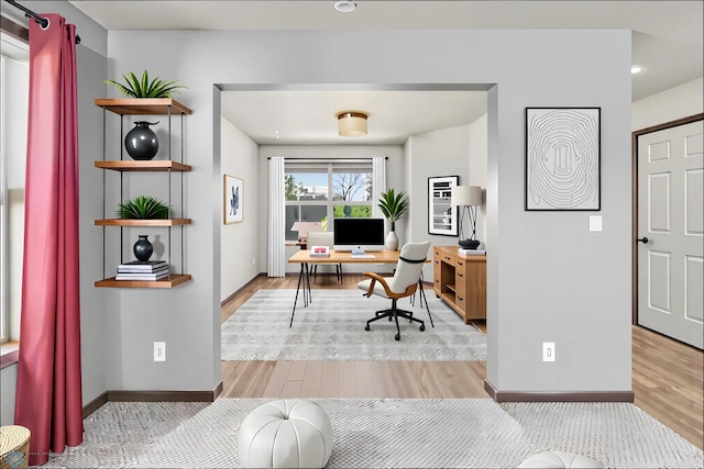office space with wood finished floors and baseboards