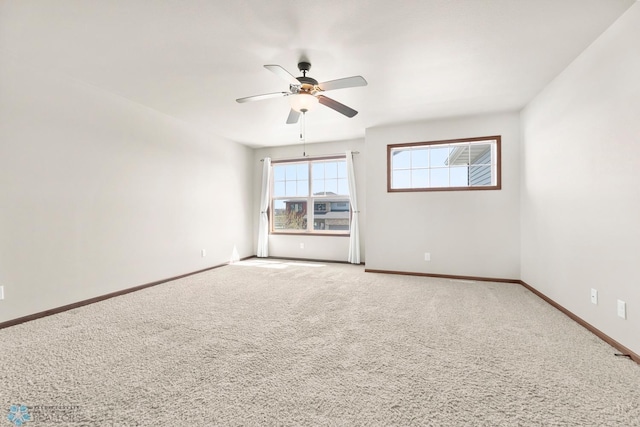 unfurnished room featuring ceiling fan, carpet floors, and baseboards