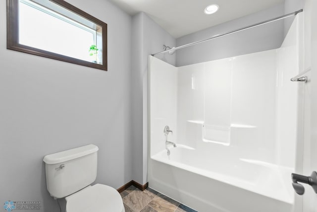 bathroom featuring baseboards, toilet, tub / shower combination, and recessed lighting